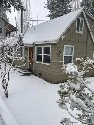 a small house with snow on the roof at Merri Bear in Big Bear Lake