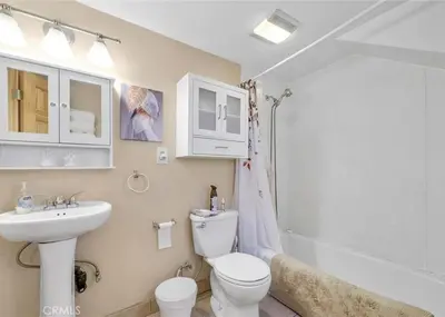 a bathroom with a toilet and a sink and a shower at Merri Bear in Big Bear Lake