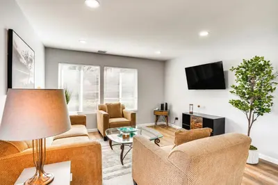 a living room with a couch and chairs and a tv at Rental with Pool Access about 8 Mi to Disneyland in La Palma