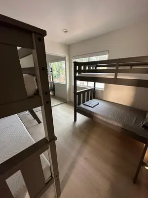 a room with two bunk beds and a window at Qazaq Hostel in Los Angeles