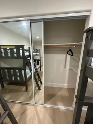 a room with a sliding glass door with a chair at Qazaq Hostel in Los Angeles