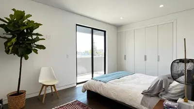 a bedroom with a bed and a potted plant at Luxurious Venice Oasis Home in Los Angeles