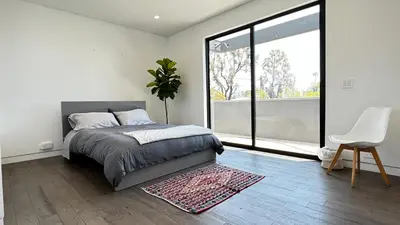 a bedroom with a bed and a large window at Luxurious Venice Oasis Home in Los Angeles