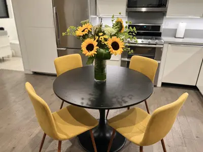 a vase of sunflowers sitting on a table in a kitchen at Cozy Luxerius 1 bed Loft Venice in Los Angeles