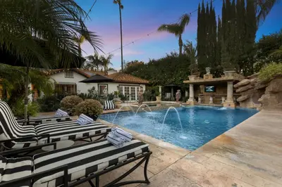 a swimming pool with two chairs and a fountain at Erwin Estate in Los Angeles