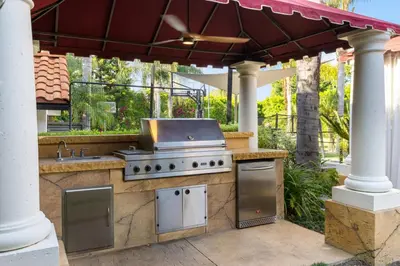 an outdoor kitchen with a grill on a patio at Erwin Estate in Los Angeles