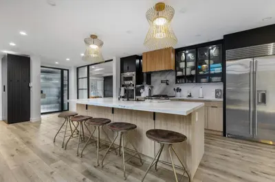 a kitchen with bar stools and a counter top at Erwin Estate in Los Angeles