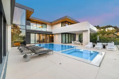a large house with a swimming pool in front of it at Swallow Sanctuary in Los Angeles