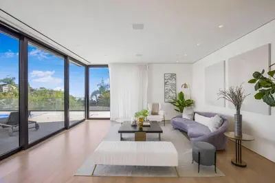 a living room with a purple couch and a table at Swallow Sanctuary in Los Angeles