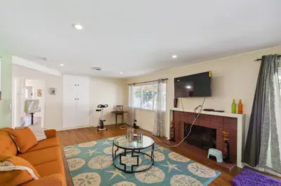a living room with a couch and a fireplace at Modern Relaxing Retreat with Private Pool home in Azusa