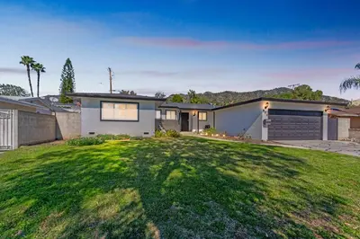 a house with a green lawn in front of it at Modern Relaxing Retreat with Private Pool home in Azusa