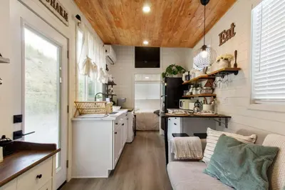a kitchen and living room in a tiny house at Tiny Farmhouse on Wheels in Santa Clarita