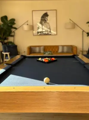 a pool table with a ball on top of it at Luxury Modern Condo 3-min from Six Flags w/PS5, 1GB Fast Wi-fi Kingbed in Santa Clarita