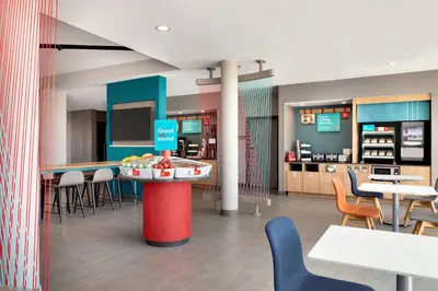 a restaurant with tables and chairs and a counter at avid hotel Victorville Hesperia by IHG in Victorville