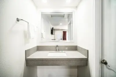 a bathroom with a sink and a mirror at Bell Manor Motel in Bell