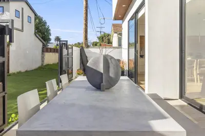 a concrete table with a vase on top of it at The Penmar Retreat - Luxurious resort-style oasis in Los Angeles