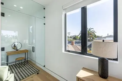 a living room with white walls and a large window at The Penmar Retreat - Luxurious resort-style oasis in Los Angeles