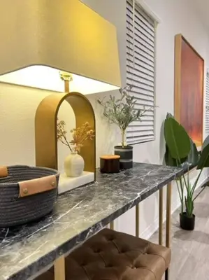a counter with a table with plants and a mirror at Up to 25% OFF / New Built for Ideal Extended Stay in Fontana