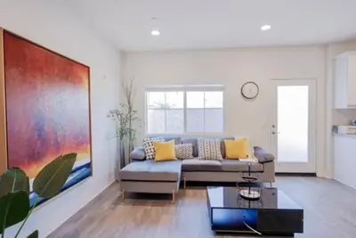 a living room with a couch and a table at Up to 25% OFF / New Built for Ideal Extended Stay in Fontana