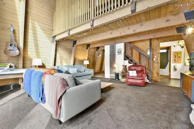 a living room with a couch and chairs and a guitar at Quail's Call Big Bear~ Walk to Lake & Ski Resort in Big Bear Lake