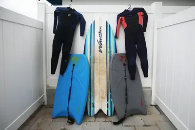 a group of surfboards are hanging on a wall at Steps 2 Beach- Luxury Home, Game Room, Roof Deck, Firepit, Pets OK in Oxnard
