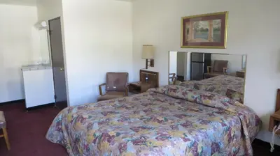 a hotel room with a bed and a chair at Eagle Rock Motel in Los Angeles