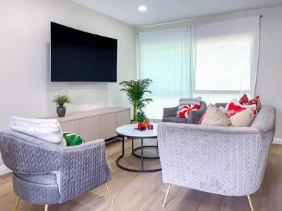 a living room with two chairs and a tv at Sweet 2 bd for monthly stay! 20 mi to Disney in Diamond Bar