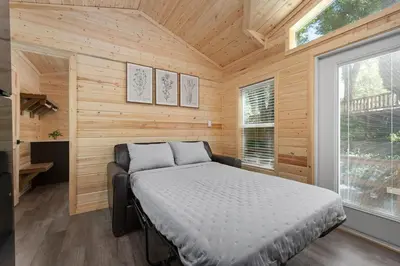 a bedroom with a bed in a wooden cabin at Brand new Cabins in Kernville