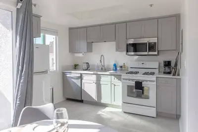 a white kitchen with white appliances and a window at 2BD/2BA Apartment in DT ALhambra in Alhambra