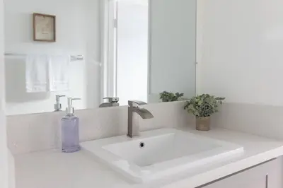a bathroom sink with a purple soap bottle on it at 2BD/2BA Apartment in DT ALhambra in Alhambra