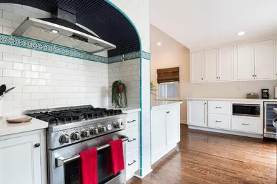 a kitchen with white cabinets and a stove with red towels at Beautiful Large 3 Bedroom 2 Bath Plus Pool and Jacuzzi in Los Angeles