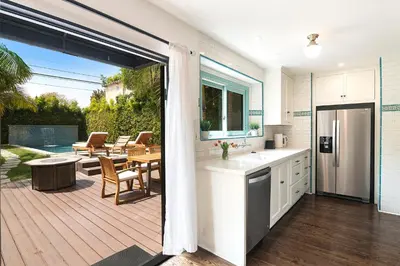 a kitchen and a patio with a table and chairs at Beautiful Large 3 Bedroom 2 Bath Plus Pool and Jacuzzi in Los Angeles