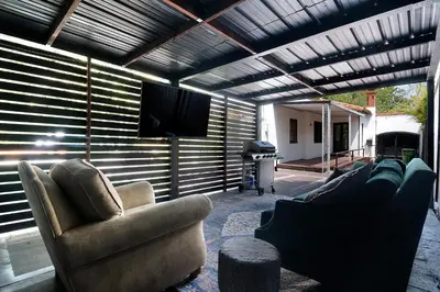 a living room with couches and a flat screen tv at Beautiful Large 3 Bedroom 2 Bath Plus Pool and Jacuzzi in Los Angeles
