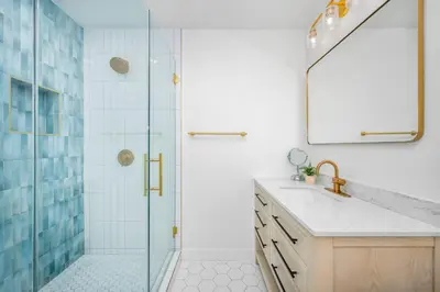 a bathroom with a shower and a sink and a mirror at 130 Anderson St A in Sunset Beach