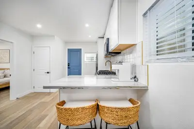 a kitchen with a counter and two stools at 130 Anderson St B in Sunset Beach