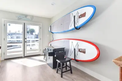 a room with two surfboards hanging on the wall at Sunset Island 3 Level Home on the Water sleeps 10 in Sunset Beach