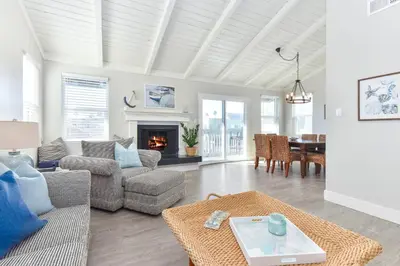 a living room with a couch and a fireplace at Sunset Island 3 Level Home on the Water sleeps 10 in Sunset Beach