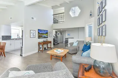 a living room with a couch and a table at Sunset Island 3 Level Home on the Water sleeps 10 in Sunset Beach