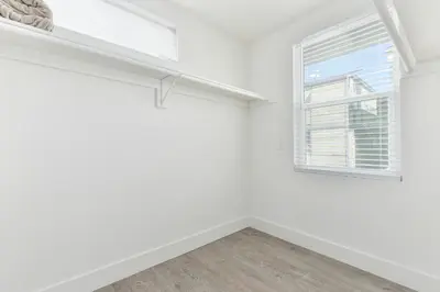 an empty room with a window and white walls at Sunset Island 3 Level Home on the Water sleeps 10 in Sunset Beach