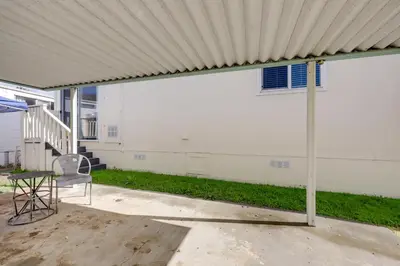 a patio with a chair and a white building at Oak View Home with Private Covered Patio! in Oak View