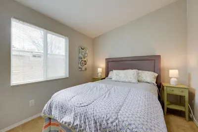 a bedroom with a bed and a window with two lamps at Oak View Home - Close to Beaches and Trails! in Oak View