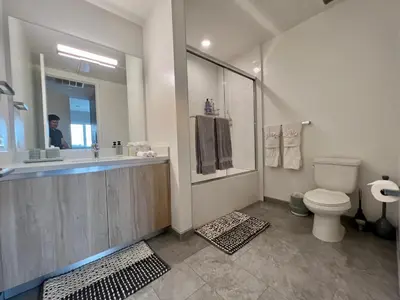 a bathroom with a toilet and a sink and a mirror at Hollywood Sign View 2 Bed 2 Bath Premium Corner in Los Angeles