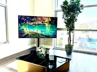 a living room with a large tv and a table at Hollywood Sign View 2 Bed 2 Bath Premium Corner in Los Angeles