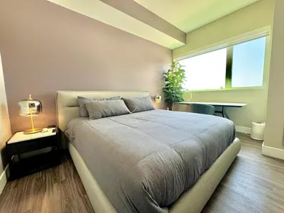a bedroom with a bed and a large window at Large Hollywood Corner 2 Bedroom with Private Balcony in Los Angeles