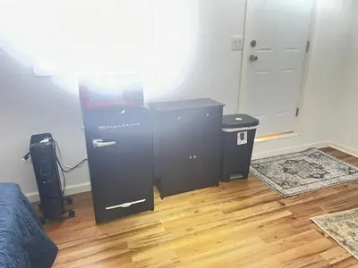 a room with a black dresser and a bed at LittleBettysCrashPad in Torrance