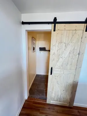 a sliding barn door in a hallway at LittleBettysCrashPad in Torrance