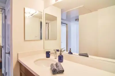 a bathroom with a sink and a mirror at Blue Agate - Seaside Bright 2BR with Marina Views in Los Angeles
