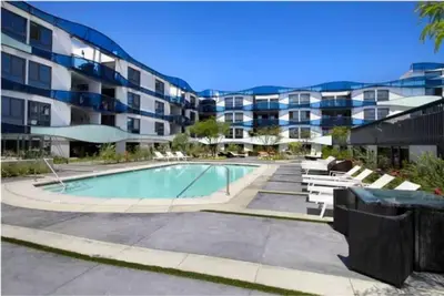 a swimming pool in front of a apartment building at Blue Agate - Seaside Bright 2BR with Marina Views in Los Angeles