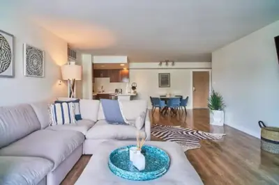 a living room with a white couch and a kitchen at Blue Agate - Seaside Bright 2BR with Marina Views in Los Angeles