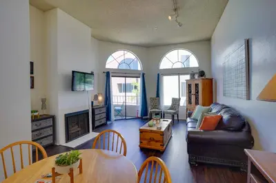 a living room with a couch and a table at 1 Mi to the Ocean Long Beach Condo with Pool Access in Long Beach